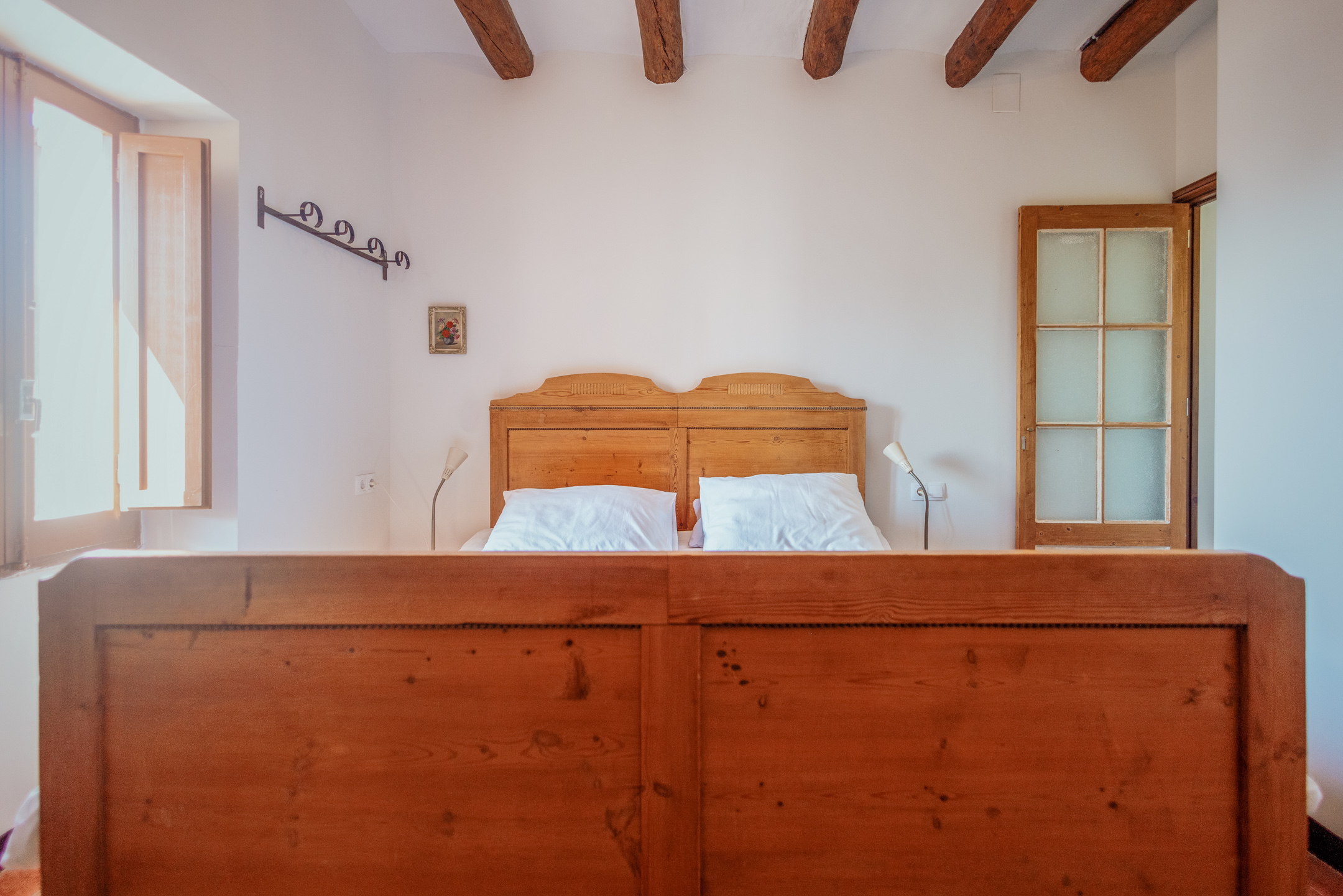 Bedroom with Bed and Window Cal Guixater 1